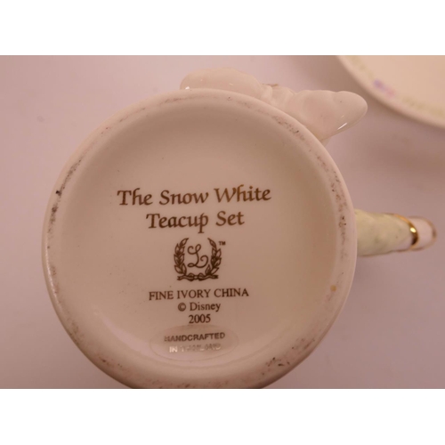 29 - A Disney 'The Snow White Teacup Set' comprising five cups and saucers, with raised decoration of the... 