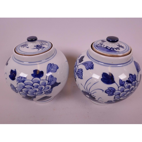 44 - A pair of Oriental blue and white porcelain storage jars and covers decorated with flowers and insec... 