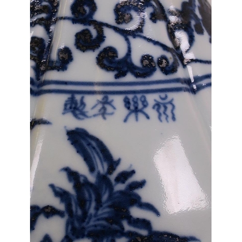 45 - A Chinese blue and white pottery pear shaped vase with butterfly and floral decoration, 4 character ... 