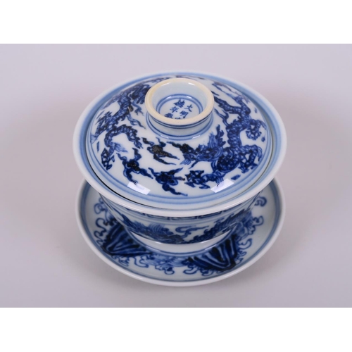 5 - A Chinese blue and white porcelain rice bowl, saucer and cover, decorated with dragons in flight, 6 ... 