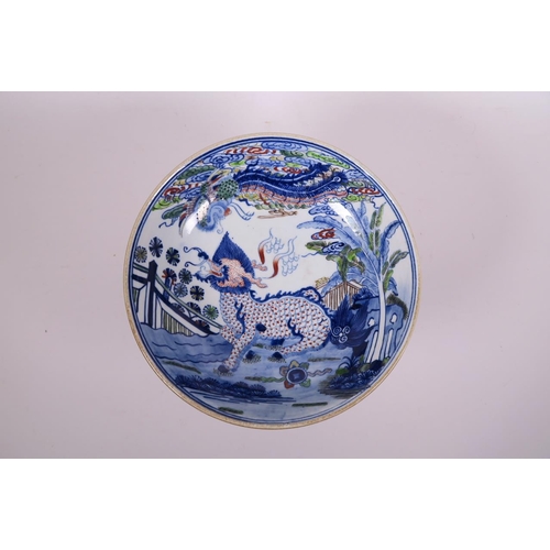 52 - A Chinese doucai porcelain stem bowl decorated with a kylin and phoenix in a garden, 8½