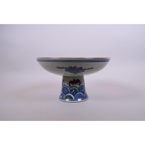 52 - A Chinese doucai porcelain stem bowl decorated with a kylin and phoenix in a garden, 8½