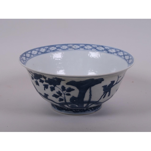 58 - A Chinese blue and white porcelain rice bowl decorated with animals in a landscape, 6 character mark... 