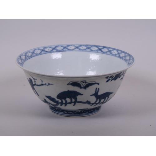 58 - A Chinese blue and white porcelain rice bowl decorated with animals in a landscape, 6 character mark... 