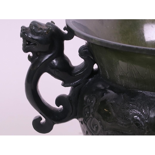 60 - A fine Chinese spinach jade two handled pot with carved dragon decoration, 5½