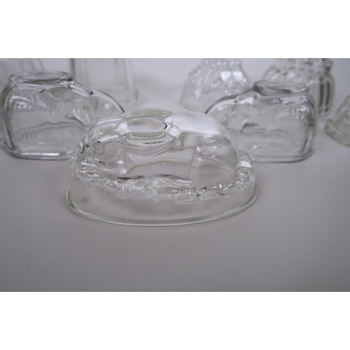 34 - A collection of glass jelly moulds, to include three in the form of rabbits, largest 7