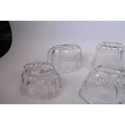 34 - A collection of glass jelly moulds, to include three in the form of rabbits, largest 7