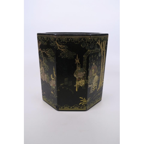 51 - A Chinese black lacquer hexagonal brush pot, with gilt enamel decoration of figures in landscape sce... 