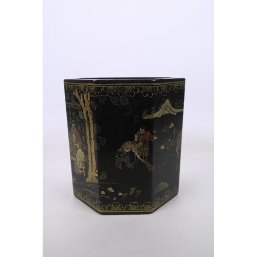 51 - A Chinese black lacquer hexagonal brush pot, with gilt enamel decoration of figures in landscape sce... 