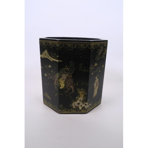 51 - A Chinese black lacquer hexagonal brush pot, with gilt enamel decoration of figures in landscape sce... 