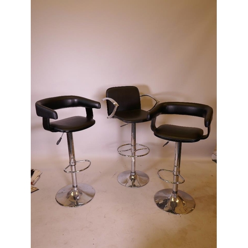 1162 - A pair of chrome and leatherette adjustable bar stools, on pedestal bases and another similar