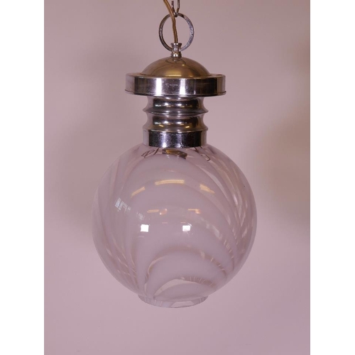 1163 - A contemporary chrome pendant light, with a swirled glass shade, 24