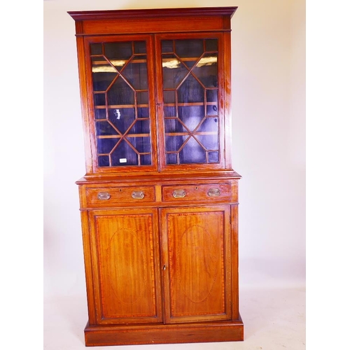 1164 - An Edwardian inlaid mahogany bookcase, the astragal glazed top in a base of two drawers and cupboard... 