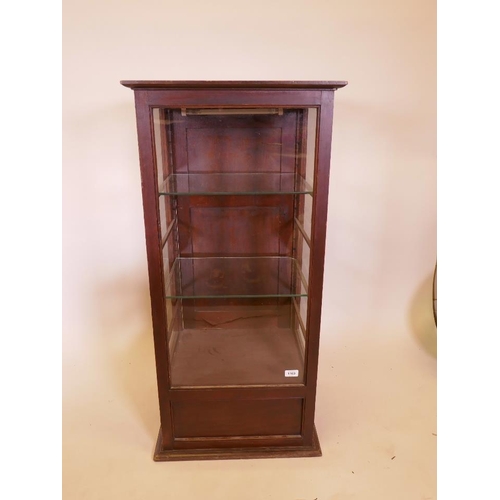 1169 - An early C20th mahogany shop display cabinet with rear door and drawer, 20