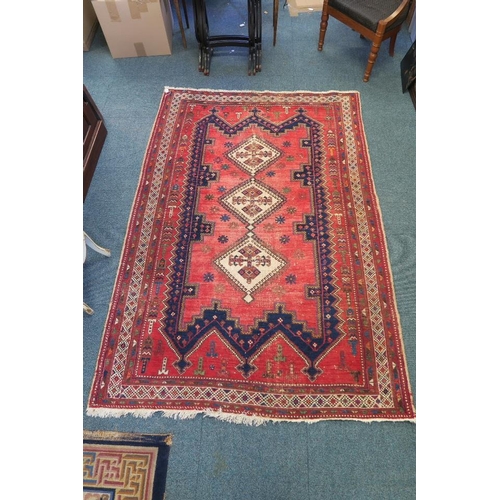 1170 - A Persian wool rug with a medallion pattern decoration on a faded field, 63