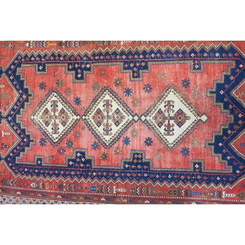 1170 - A Persian wool rug with a medallion pattern decoration on a faded field, 63