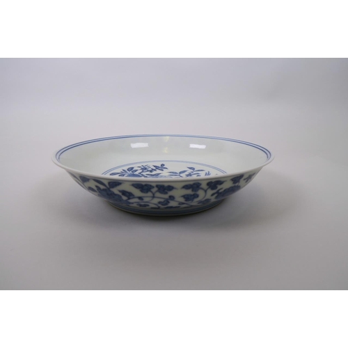 13 - A Chinese blue and white porcelain dish decorated with exotic birds perched on a peach tree, 6 chara... 