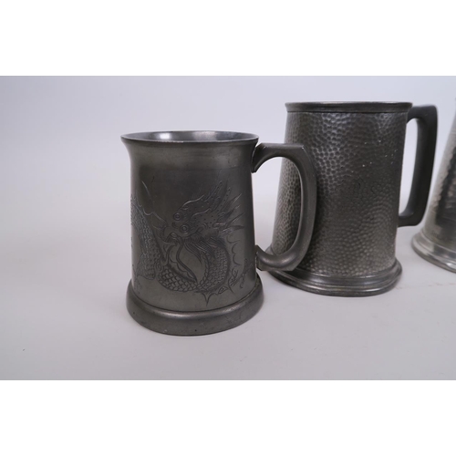 16 - A collection of four pewter tankards, one with engraved Chinese dragon decoration, largest 5