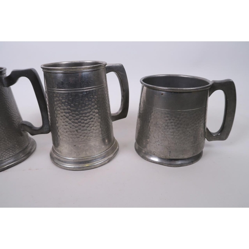 16 - A collection of four pewter tankards, one with engraved Chinese dragon decoration, largest 5