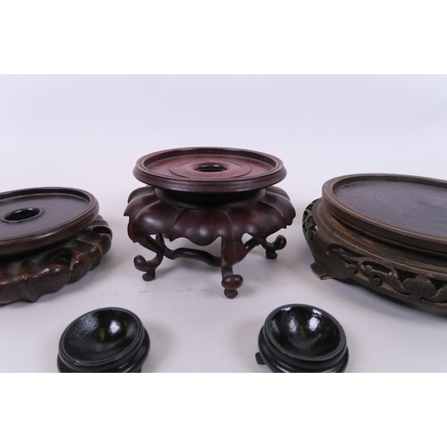 19 - A quantity of Chinese carved hardwood stands of assorted sizes, largest 6½