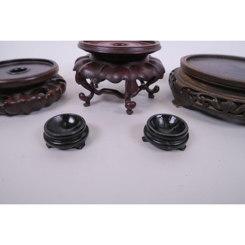 19 - A quantity of Chinese carved hardwood stands of assorted sizes, largest 6½