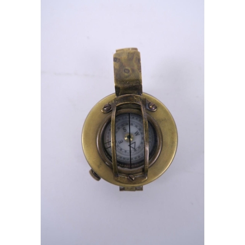 22 - A reproduction brass cased military field compass, engraved 'T.G. and Co. Ltd., London', 2½