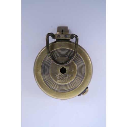 22 - A reproduction brass cased military field compass, engraved 'T.G. and Co. Ltd., London', 2½