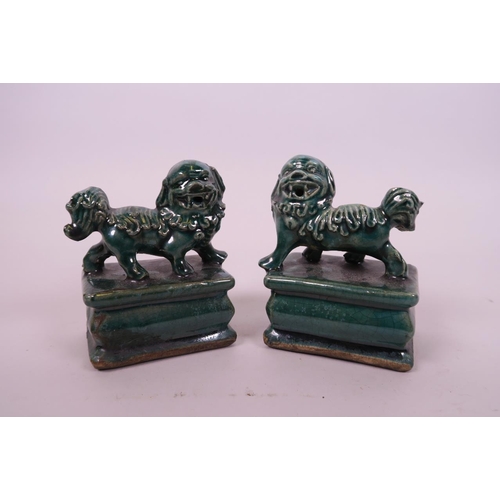 26 - A pair of Chinese green crackle glazed pottery seals surmounted by kylin, 4