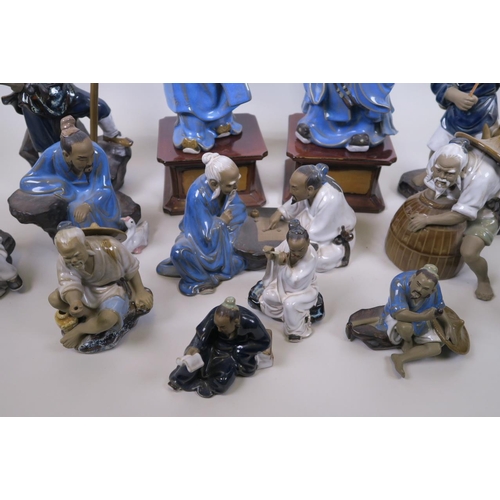 27 - A large collection of Chinese mudman pottery figures of elders, largest 16½