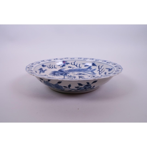 10 - A Chinese blue and white porcelain dish with lobed rim, decorated with a dragon and phoenix chasing ... 