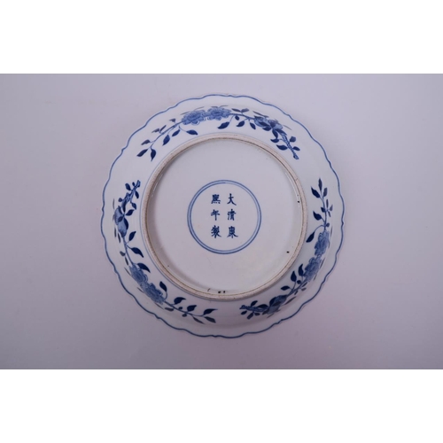 10 - A Chinese blue and white porcelain dish with lobed rim, decorated with a dragon and phoenix chasing ... 