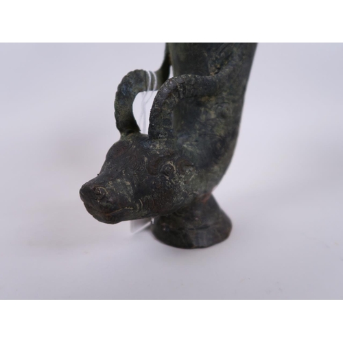 24 - A Chinese bronze libation cup, the handle formed as a goat's head, impressed 4 character mark to bas... 