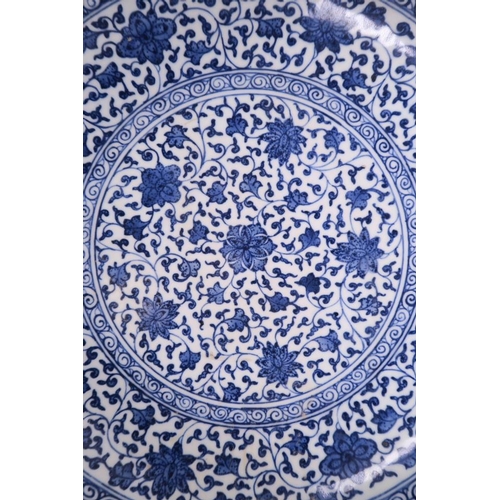 25 - A Chinese blue and white porcelain charger with scrolling floral decoration, 12