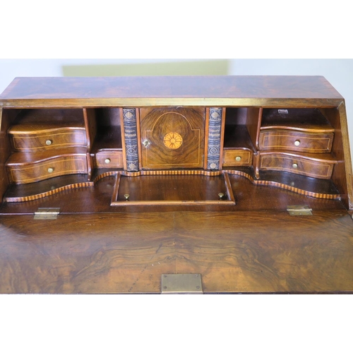 1201 - A C18th style Dutch bombe shaped bureau, the fall front with fitted interior, over three drawers, ra... 