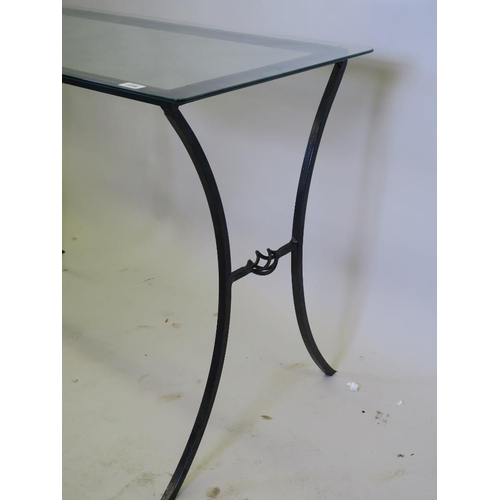 1204 - A wrought metal side table with glass top, 42