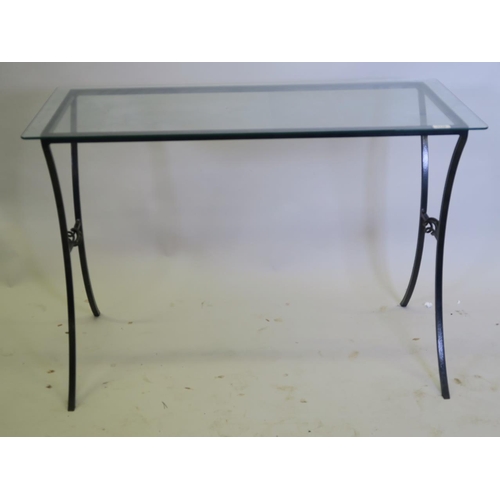 1204 - A wrought metal side table with glass top, 42