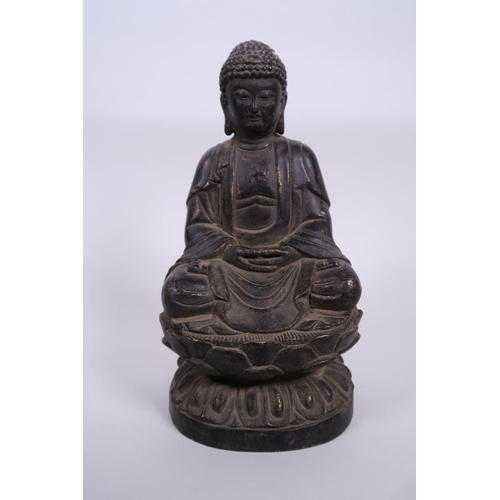 11 - A Chinese bronze figure of Buddha seated on a lotus throne with a gilt patina, 8