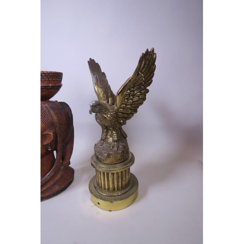 18 - A gilt metal lamp base in the form of an eagle and an African carved bust, 17