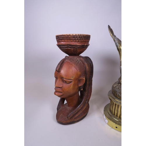 18 - A gilt metal lamp base in the form of an eagle and an African carved bust, 17