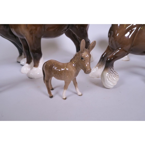 42 - A collection of Beswick animals to include two large shire horses, a smaller shire horse, a canterin... 