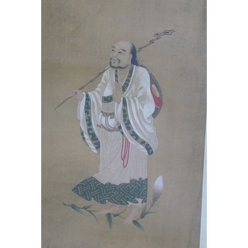 44 - A Chinese watercolour scroll depicting an immortal in white robes, 15½