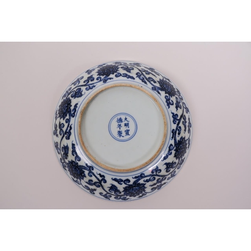 45 - A Chinese blue and white porcelain dish with scrolling lotus flower decoration, 6 character mark to ... 