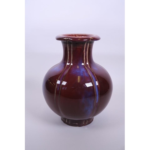 53 - A large Chinese red flambé glazed pottery vase with a lobed rim, 6 character mark to base, 10½