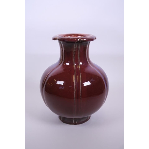 53 - A large Chinese red flambé glazed pottery vase with a lobed rim, 6 character mark to base, 10½