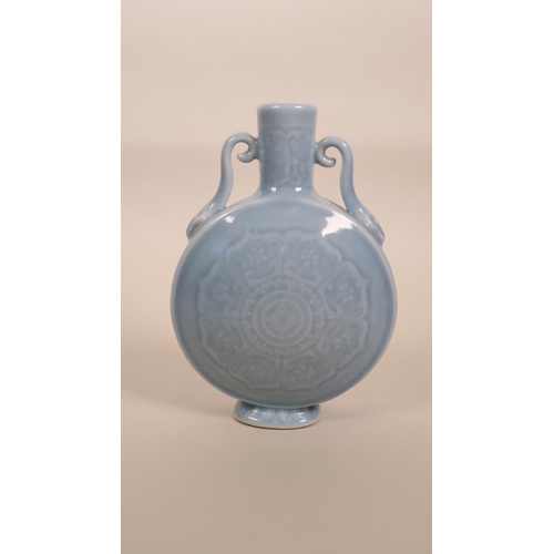 55 - A small Chinese powder blue glazed moon flask with two handles and foliate underglaze decoration, se... 