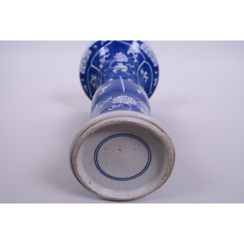 6 - A Chinese blue and white gu shaped porcelain vase, decorated with figures and flowers, 9