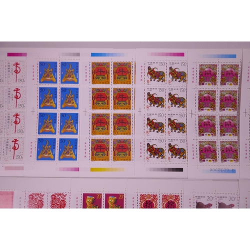 11 - A collection of 24 facsimile (replica) Chinese stamp sheets decorated with animals of the zodiac, 9½... 