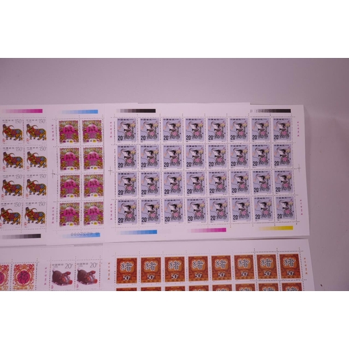 11 - A collection of 24 facsimile (replica) Chinese stamp sheets decorated with animals of the zodiac, 9½... 