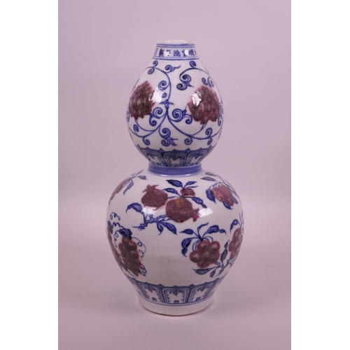 18 - A Chinese blue and white double gourd vase with red fruit and lotus flower decoration, 6 character m... 