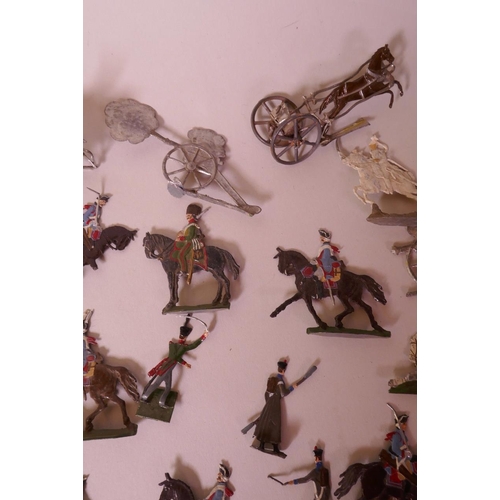 46 - A collection of over seventy early flat back toy soldiers including infantrymen, cavalry, cannon etc... 